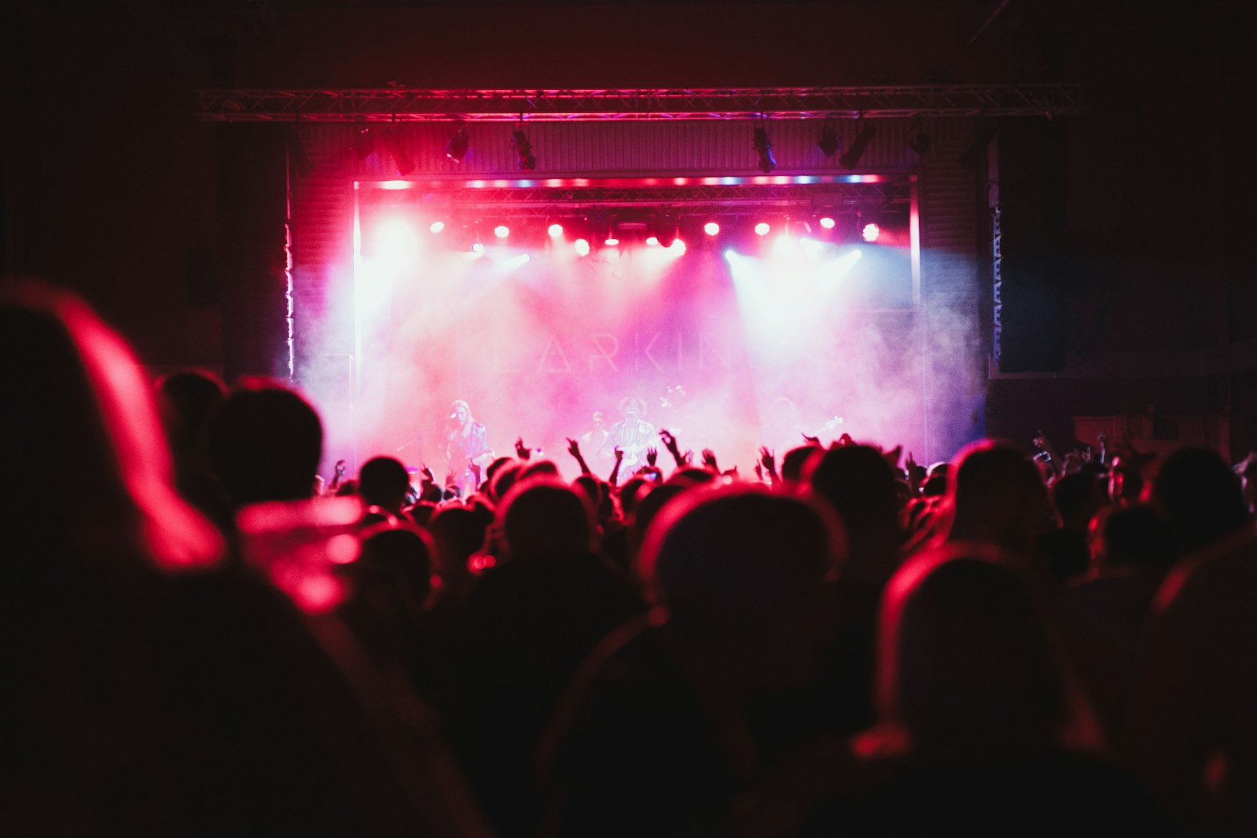 A crowd under stage lights at night